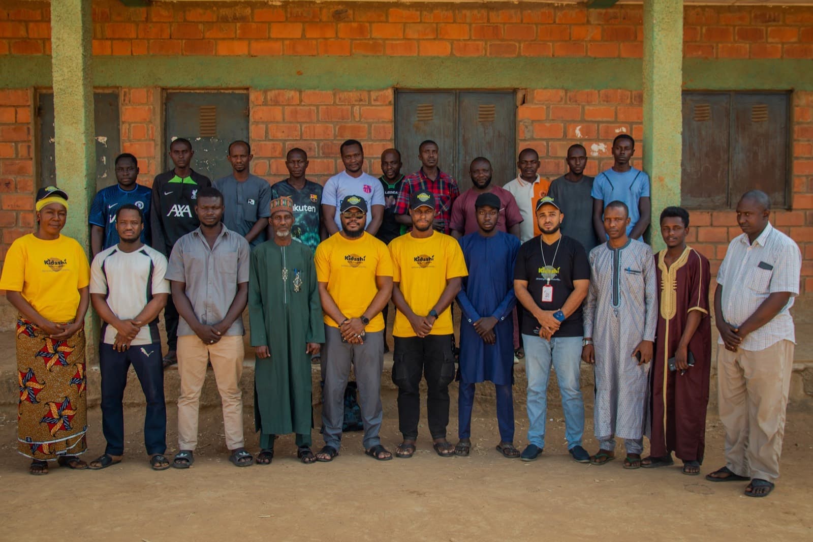 Participants and Kidashi field agents together after a literacy session