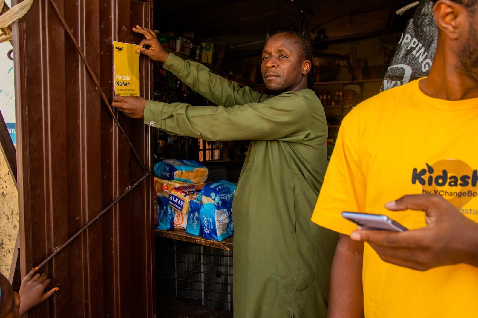 An agent with a shopkeeper inside his store
