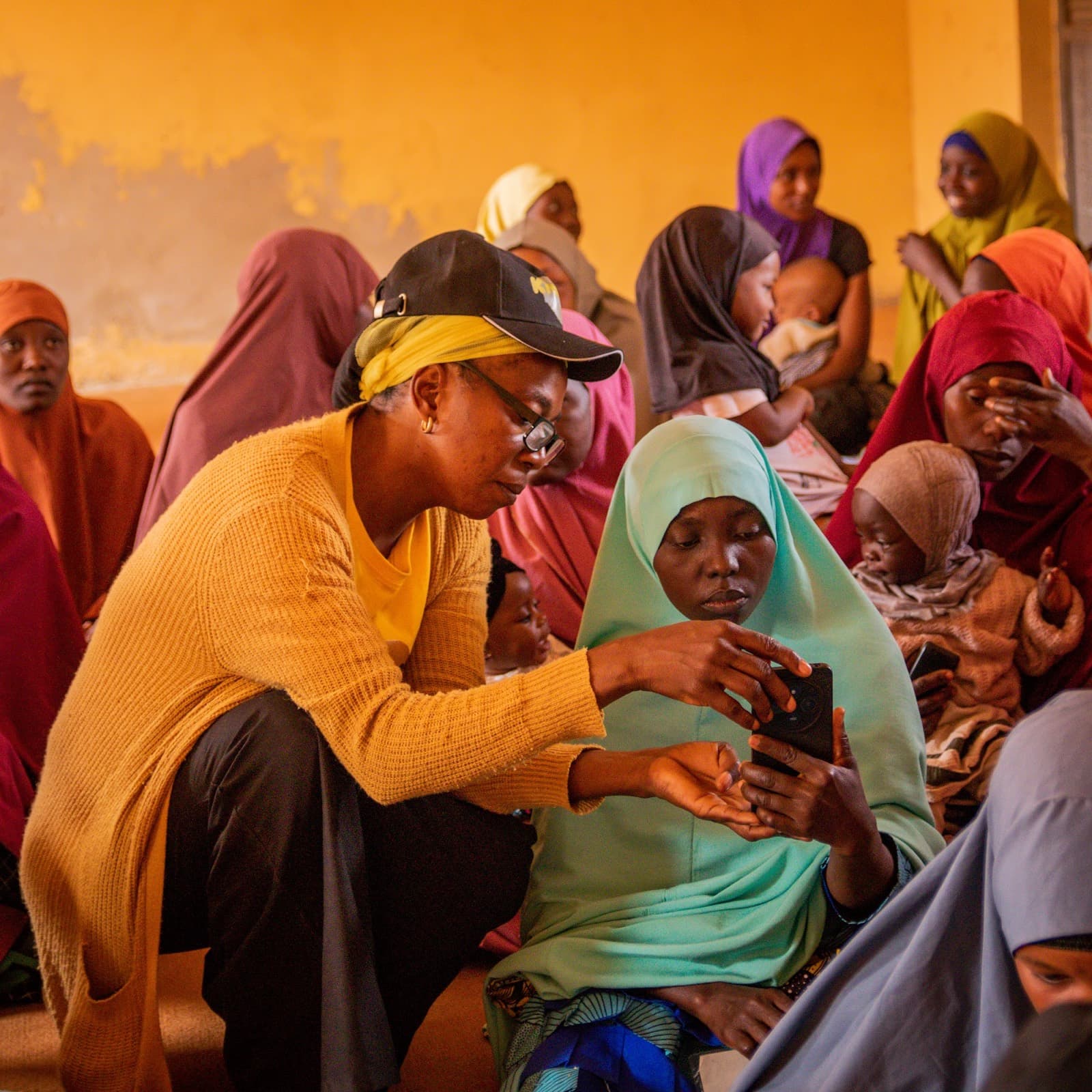 An agent working through onboarding with a group of women