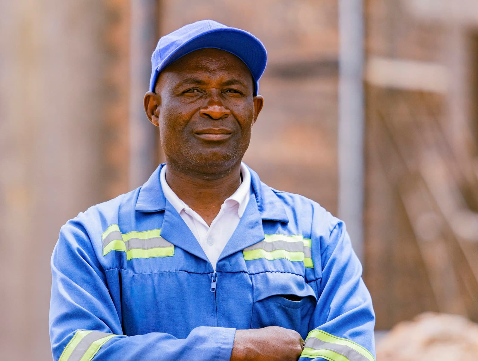 A distributor in a blue work uniform standing at his depot